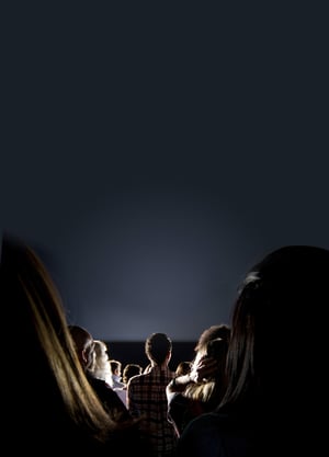 Group of people looking at the screen at the cinema