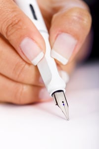business hand and pen signing a contract