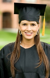 graduation woman portrait smiling and looking happy outdoors